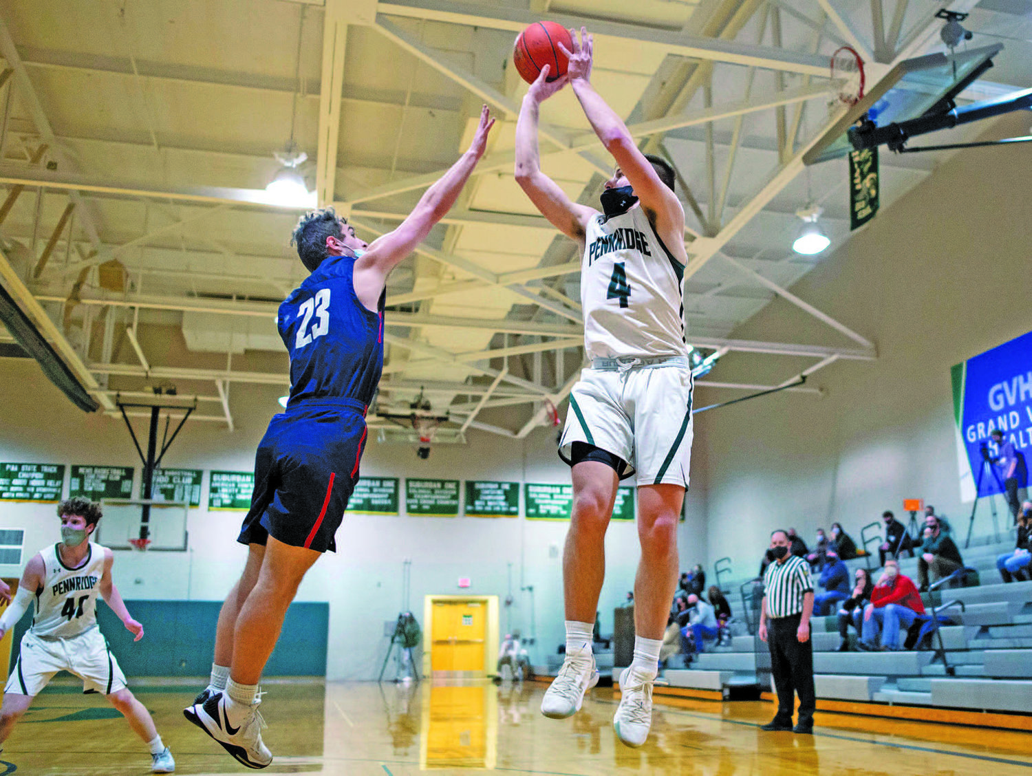 Pennridge’s Luke Yoder gets a shot off against CB East’s Joe Jackman during a Jan. 12 contest between the Patriots and Rams in Perkasie. CB East defeated Pennridge 62-48. After a month’s delay, the winter sports season is finally underway in Bucks County.