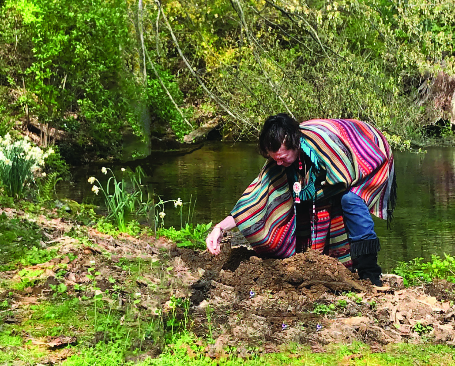 Barbara Bluejay Michalski prepared the earth for the planting of an Eastern red cedar next to Aquetong Spring. The tree replaced a decayed cedar that had been planted by her grandfather, Chief Whippoorwill, Bill Thompson.