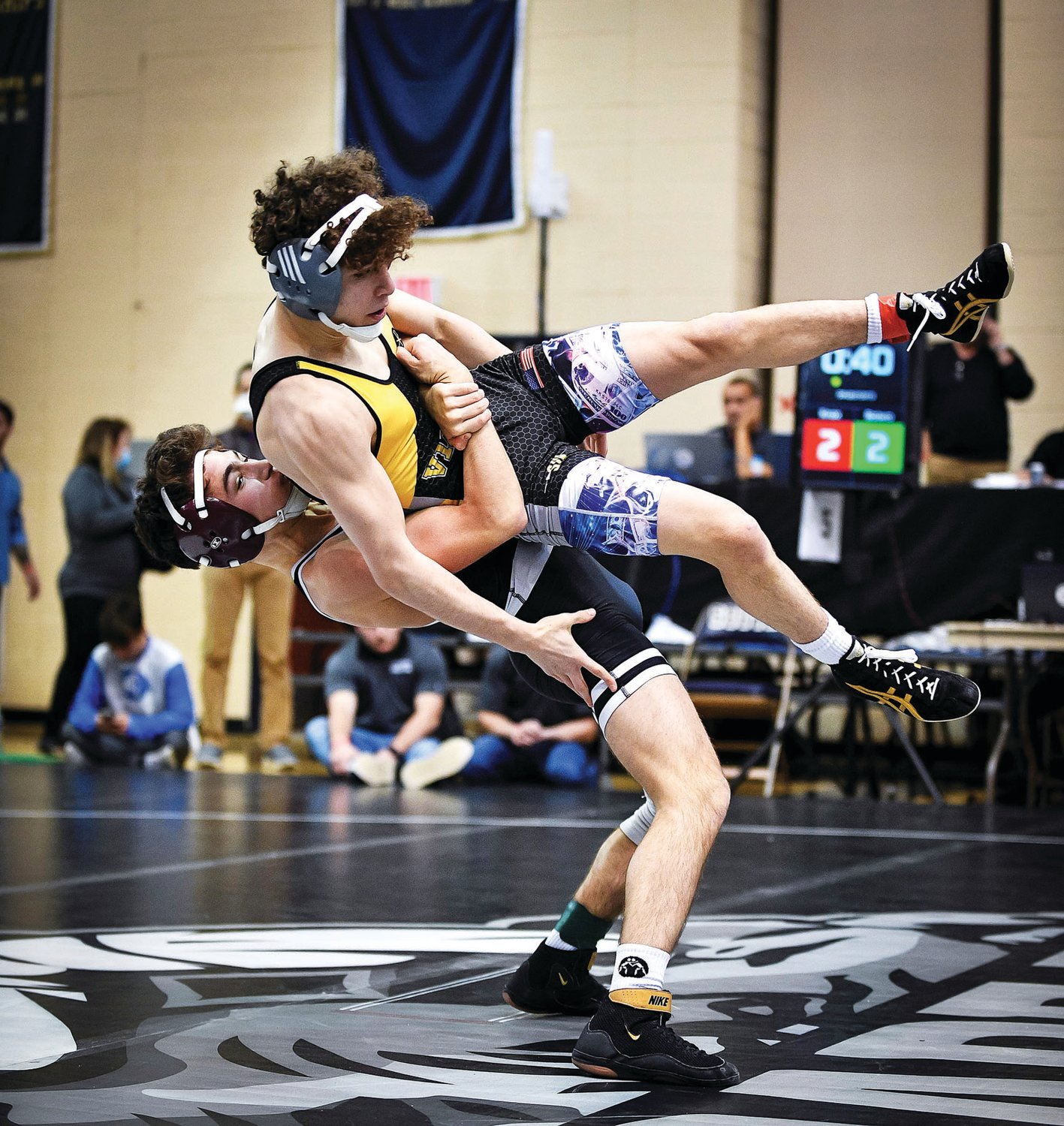 Faith Christian Academy’s Gauge Botero picks up and slams Anthony Knox of St. John Vianney, but Knox would recover and score a last-second point to edge Botero 9-8 in a 113-pound match.