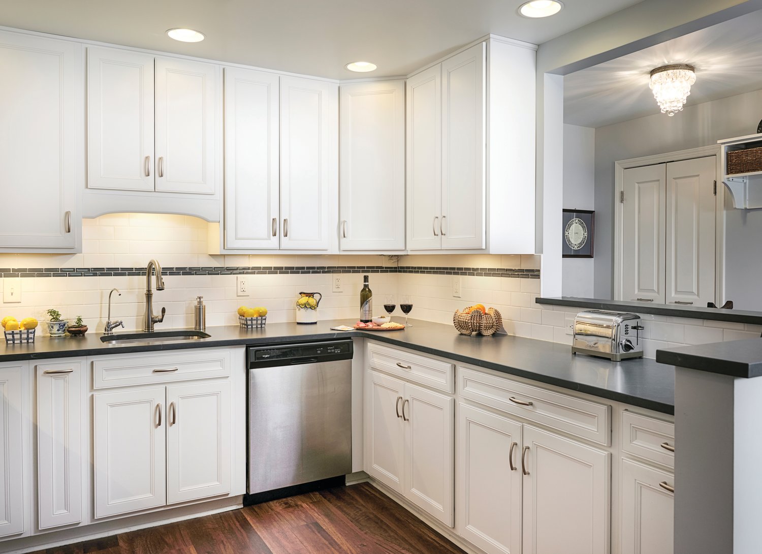 The Bings’ sparkling white kitchen is a central part of their apartment’s open floor plan.