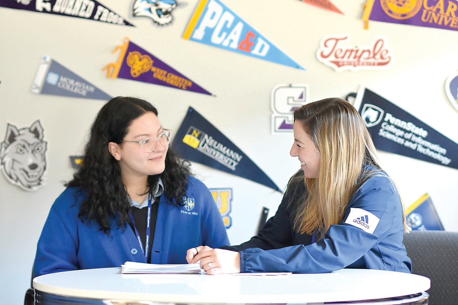 Emily Bray, a school counselor at Conwell-Egan, sits with senior Gabriella Cain in the Counseling Center to discuss college and career planning.