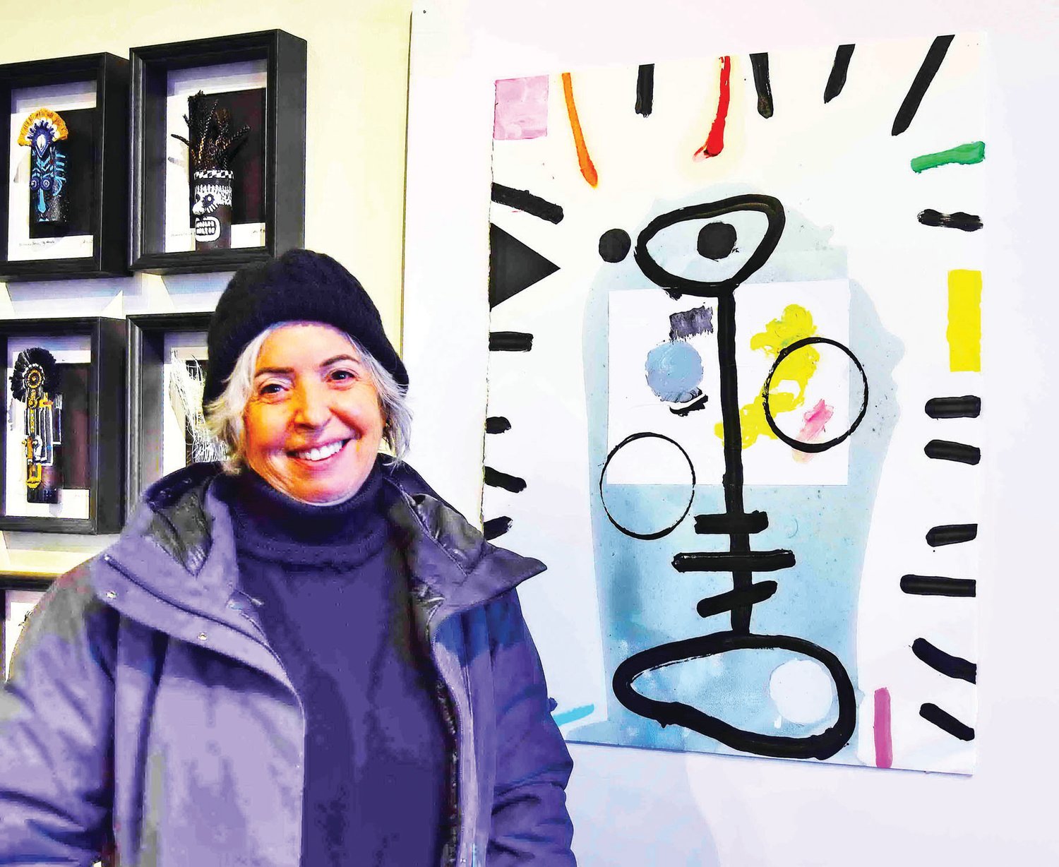 Mariam Tucker with a painting by Lee Kaloides titled “11-30-21,” in mixed media on paper.