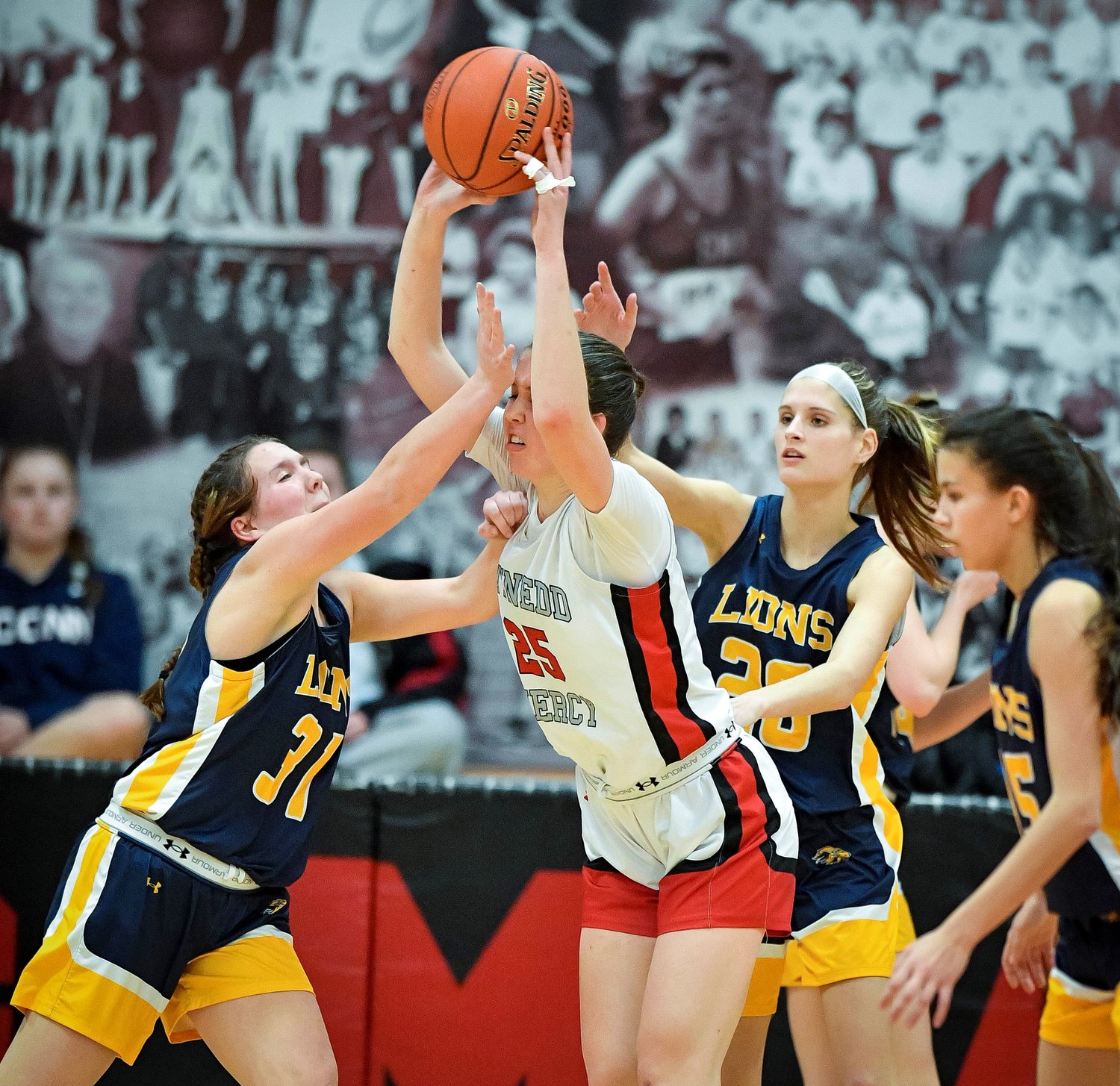 Gwynedd Mercy’s Dylan Burke gets double teamed by New Hope’s Emily Wilson and Emma Ives.