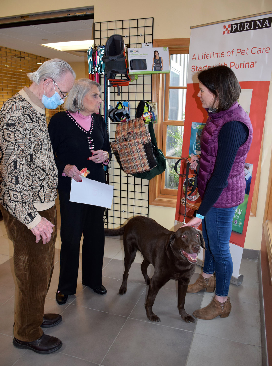 Marcia Hill, a former Bucks County SPCA board member, and her husband greet Michelle Elsesser, the Quakertown shelter’s first adopter, and Rex.