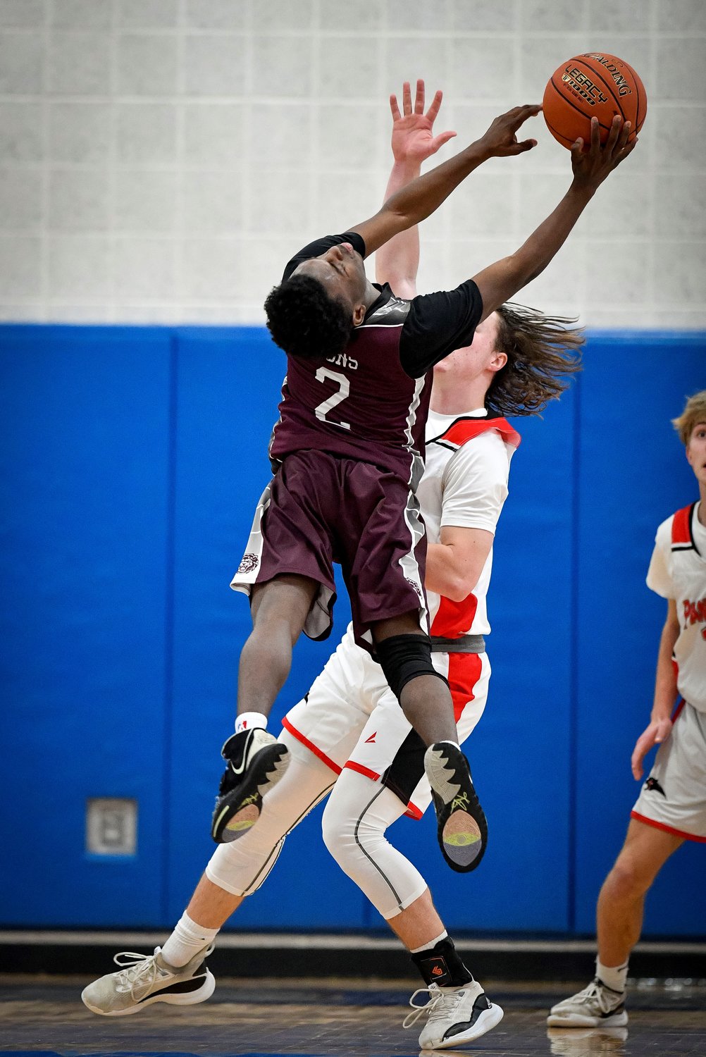 Faith’s Gerald Pinkney bends backwards for a rebound in front of Plumstead’s Jackson Mott.