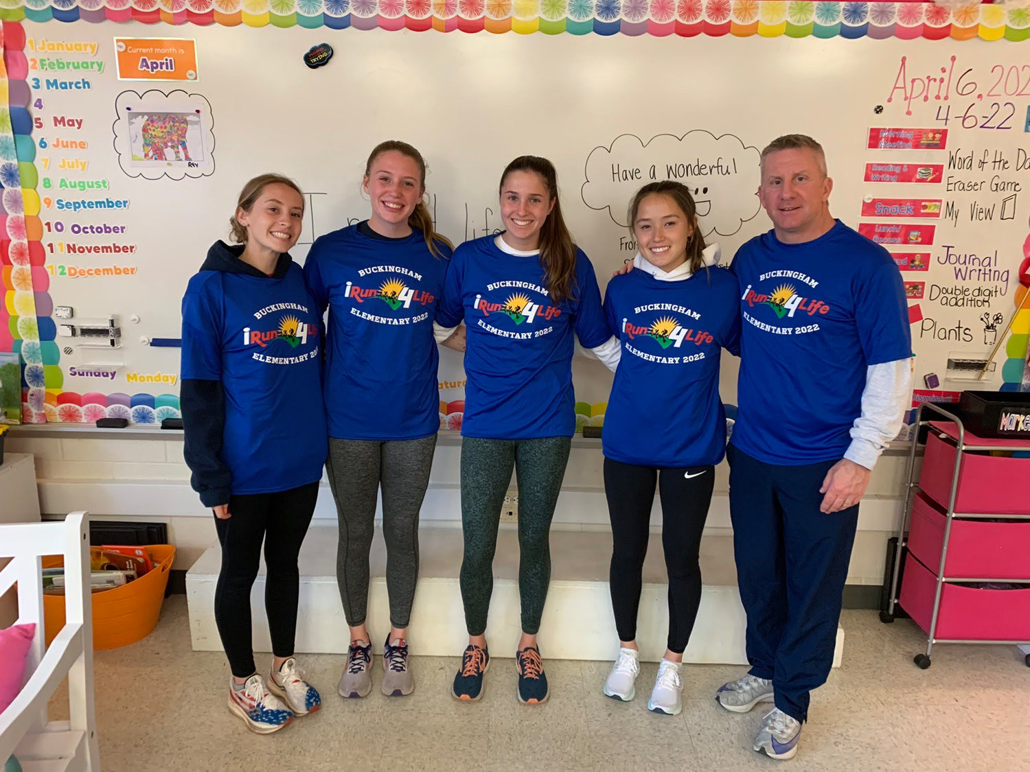 CB East girls track team captains and coach Steve Martin at Buckingham Elementary’s iRun4Life.