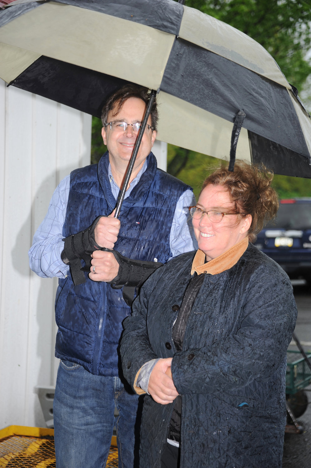 Ed Sueta and Laura Kearny Sueta brave the rain and winds.