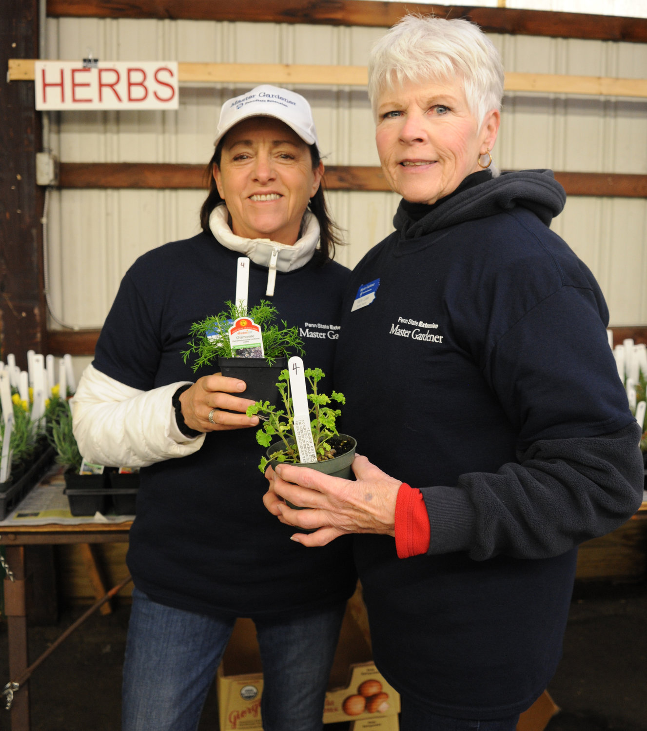 Kathy Lees and Donna Collins man the herb booth.