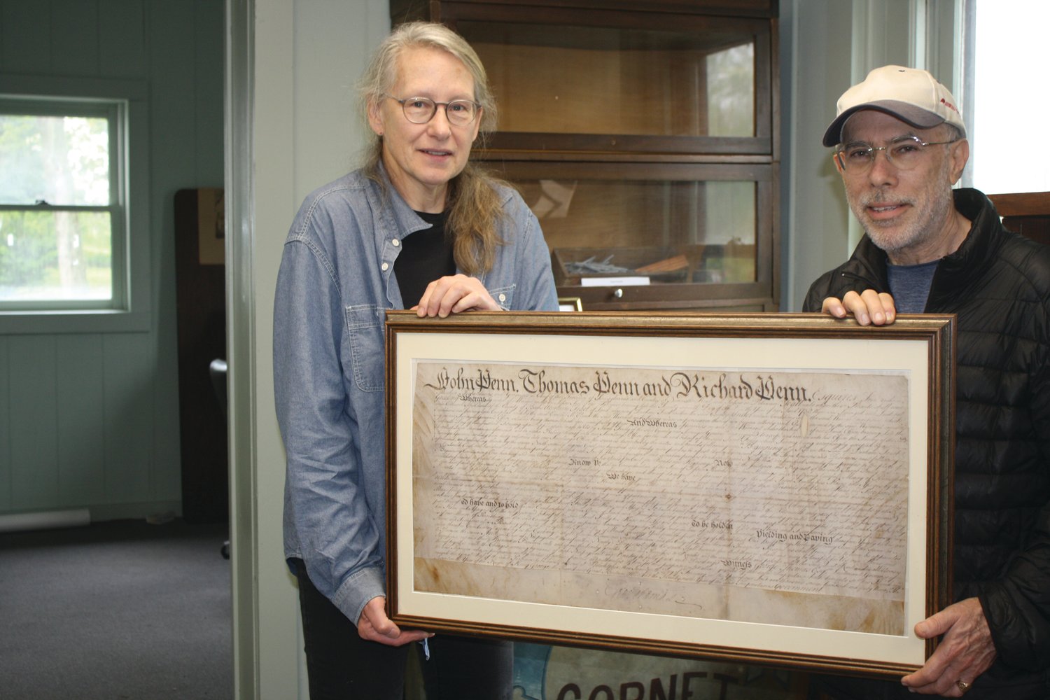 Lois Oleksa and Stephen Willey show a copy of a 1737 document signed by the sons of William Penn granting land and mining rights to the Durham Iron Company.