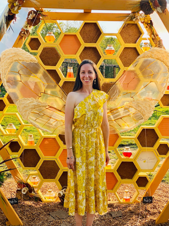 Renee Tucci of Chalfont poses in front of her honey hive design, exhibited at the 2021 Philadelphia Flower Show.