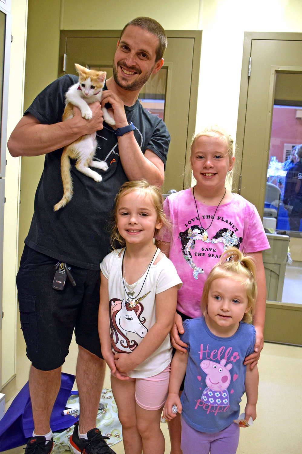 Jason Antonowicz and daughters Alayna and Angelina and Mollie Prodorutti hold a kitten.
