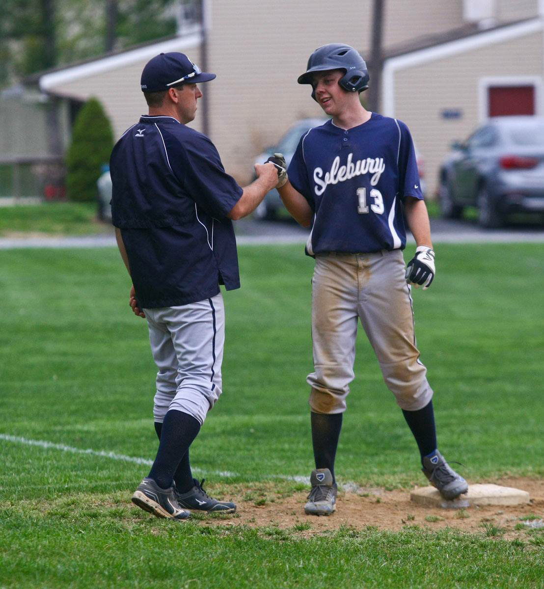 Rob Eichem, who served as Solebury School’s athletic director and varsity baseball coach, gives one of his players a fist bump.
