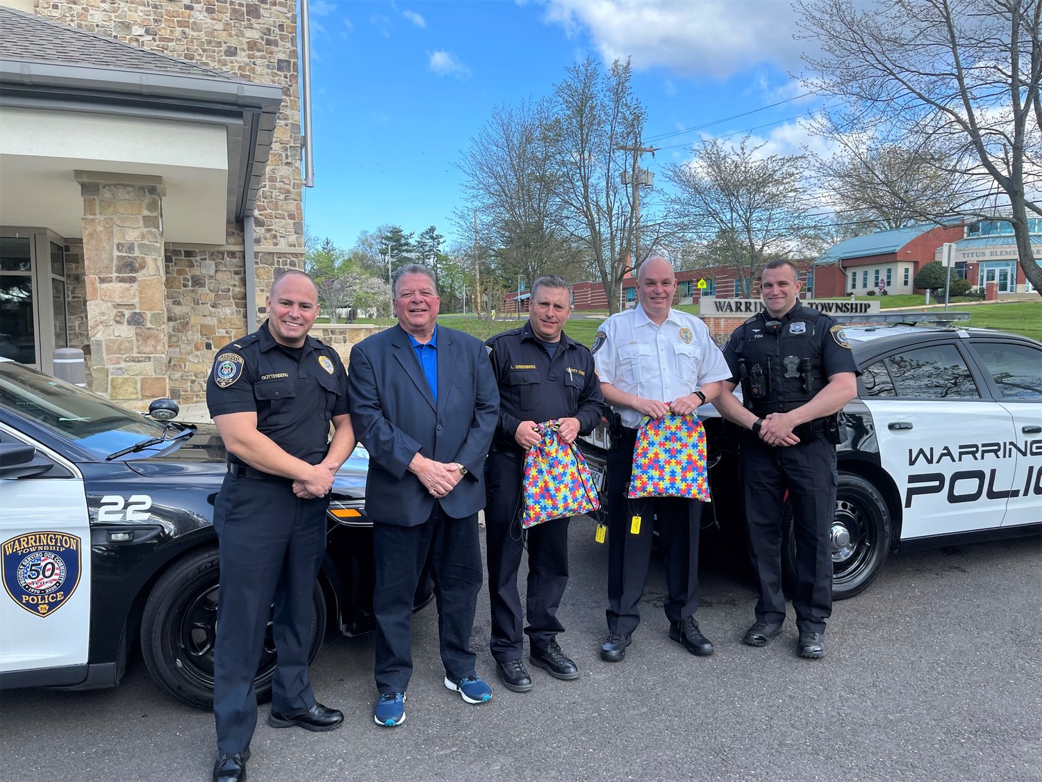 Warrington Rotary Club President Lou Altomari presents the Warrington Township Police Department with Autism Sensory Kits. These kits will be used to help to calm a person with autism on occasions when they come into contact with police officers. From left are: Lt. Glen Gottenberg, Warrington Township Police Department; Altomari; Lee Greenberg, director of emergency services, Warrington Township; Chief Daniel Friel, Warrington Township Police Department; Officer Nate Coia, Warrington Township Police Department.