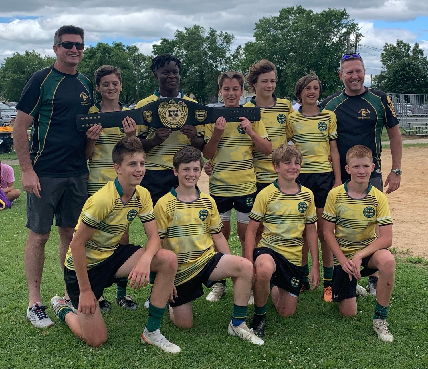 The Doylestown Rugby Academy youth team celebrates winning the Delco 7s Tournament on June 18. From left are: kneeling, Mason Darrows, Liam Hoey, Jackson Reilly, Sean Leuthe; standing, coach Kevin Reilly, Brady Meehan, Gavin Graham, Nick Miletto, Davis Parisi, Jamie Weir and coach Mark Weir.