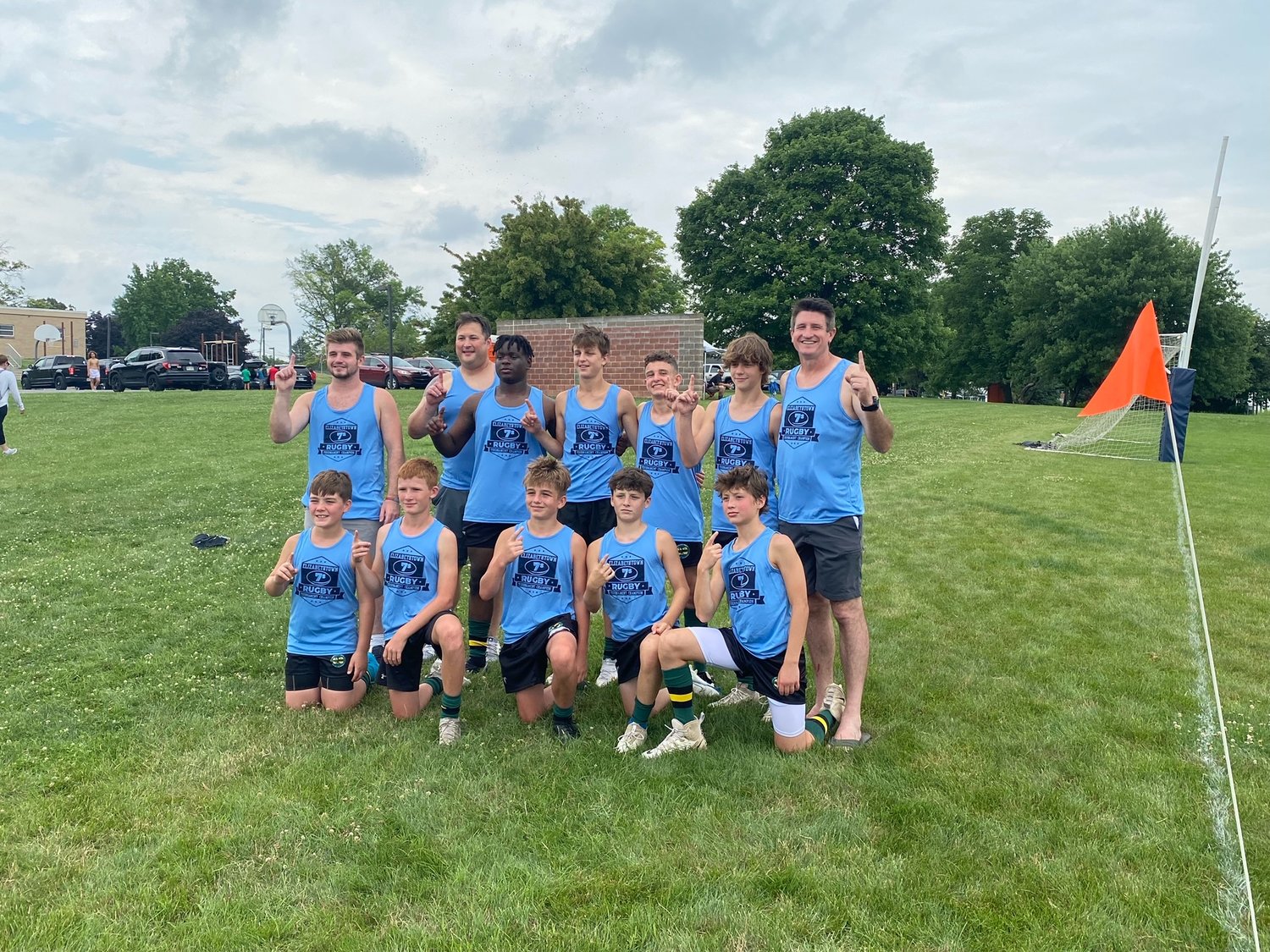Members of the Doylestown Rugby Academy youth team wear their championship tank tops. From left are: kneeling, Sean Harding, Sean Leuthe, Jackson Reilly, Liam Hoey, Louie Cipollo; standing, coach Kevin Reilly Jr., coach Lou Cipollo, Gavin Graham, Mason Darrows, Brendan Bieker, Davis Parisi and coach Kevin Reilly