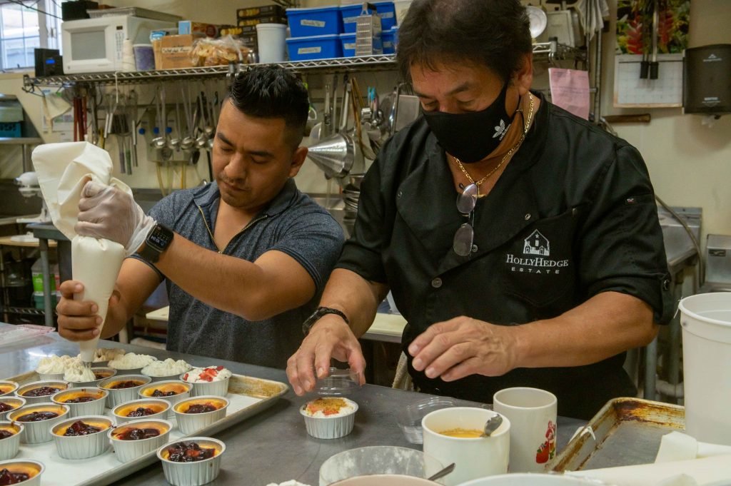 Chef Jose Calderon, right, prepares a dessert with his students.
