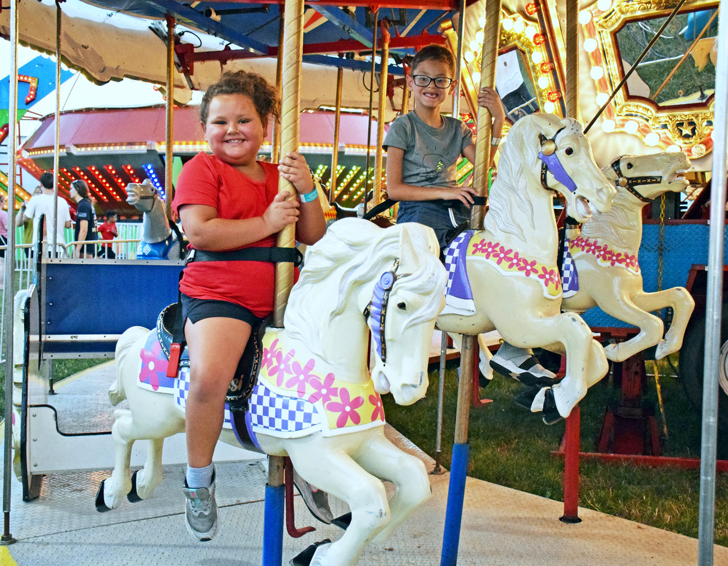 Jayla and Bently Shelton of Doylestown ride the ponies on the carousel.