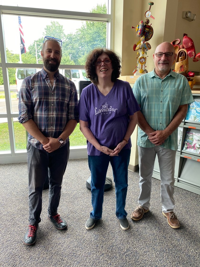 Sculptor Kathleen McSherry is framed by A&C Board member Vincent Hawley and Library Director Dennis Stranz.