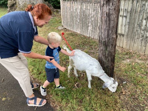 Knowles Doyle American Legion Post 317 Vice Commander Candace Carver helps her grandson, Turner Carrillo, pet a goat during the grand opening for the new KidsBerry Academy Day Care in Yardley Borough that is located at the Legion post.