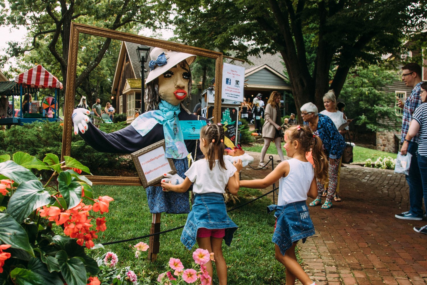 Visitors take a look at the scarecrows lining the paths at Peddler’s Village.