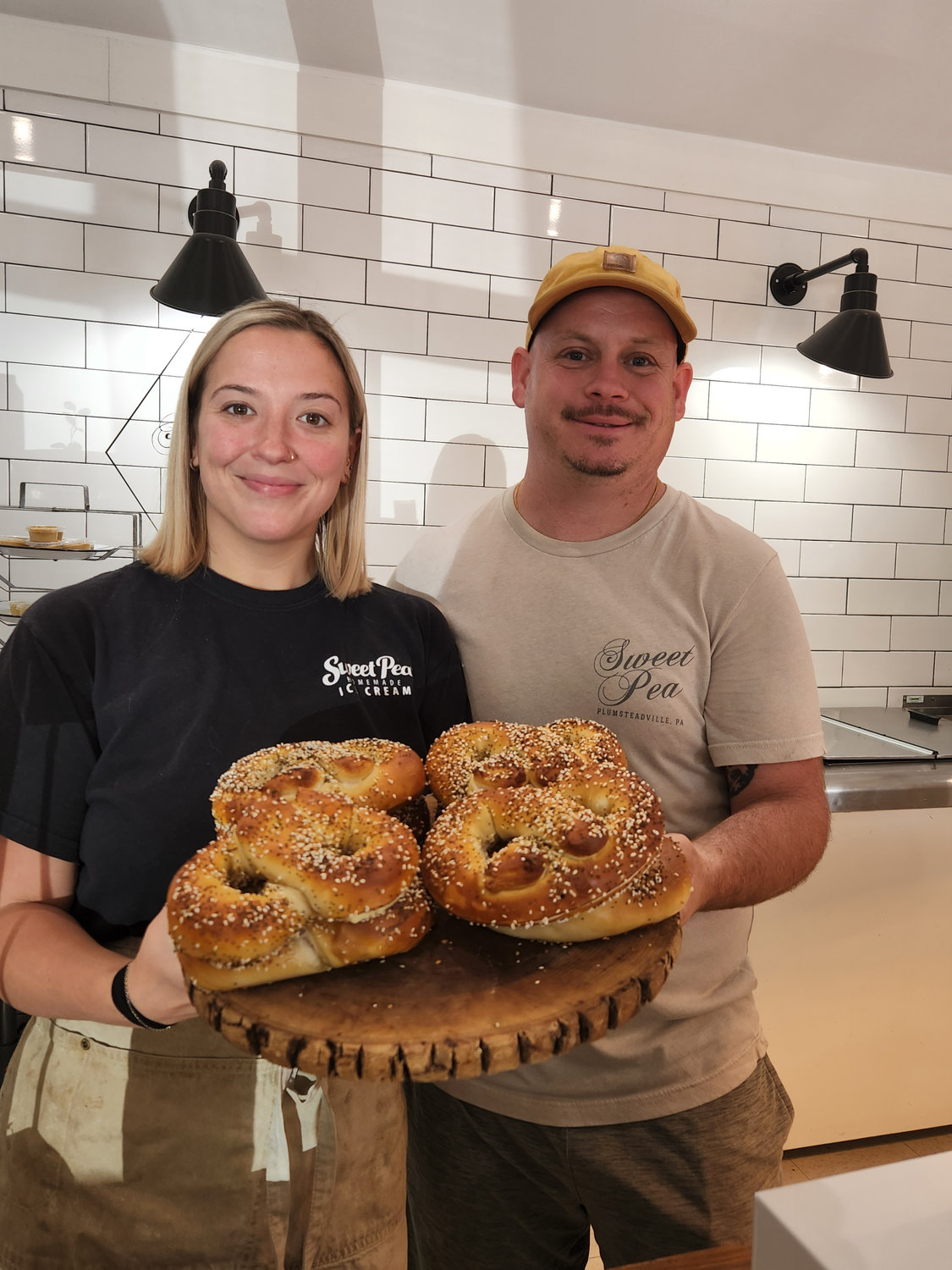 Olivia Marinelli and cousin and fellow employee Josh Green
show off a platter of Salt Box pretzels.