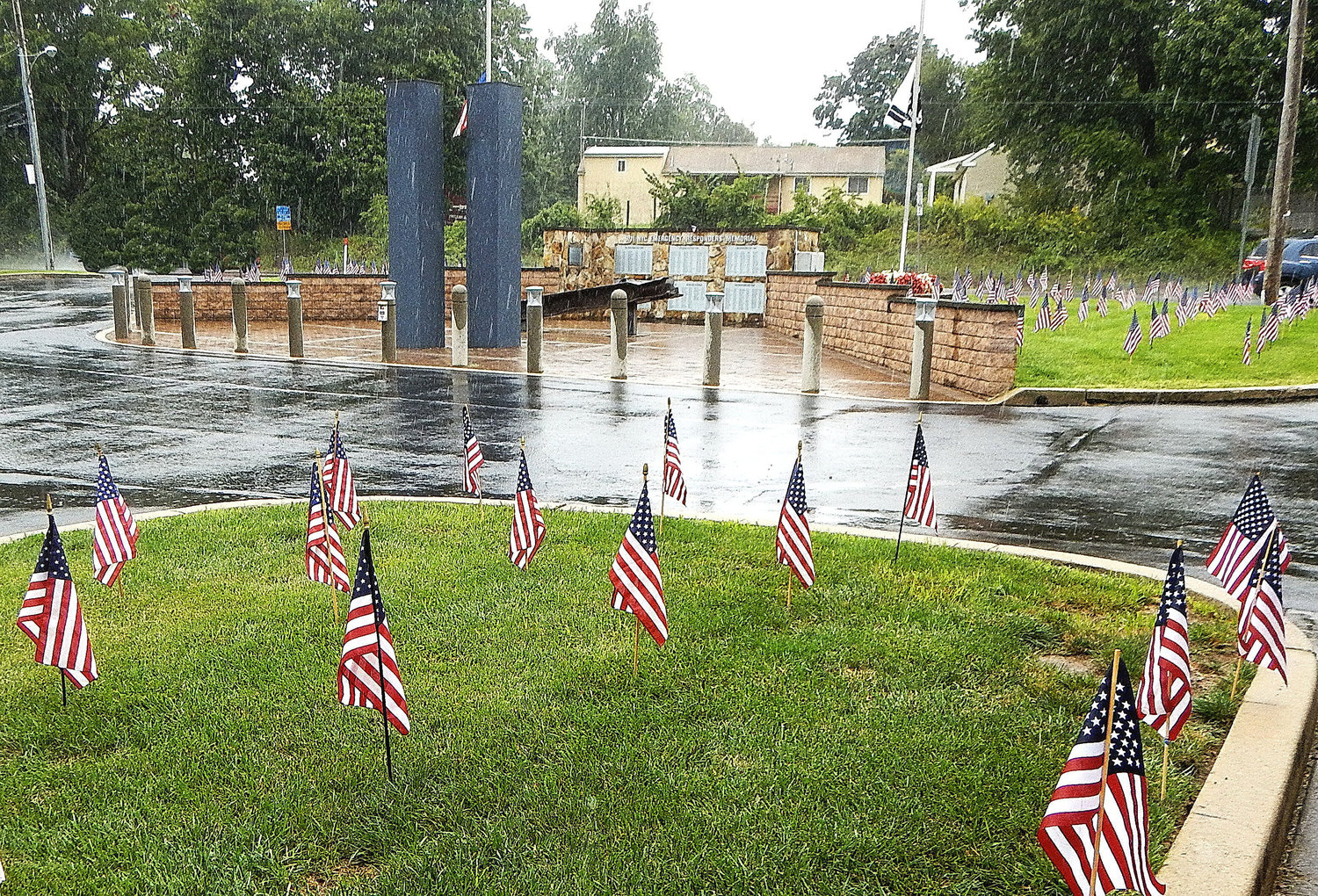 The rain pours down on the Hartsville Fire Company’s 9/11 display, consisting of 403 American Flags and models of the Twin Towers.