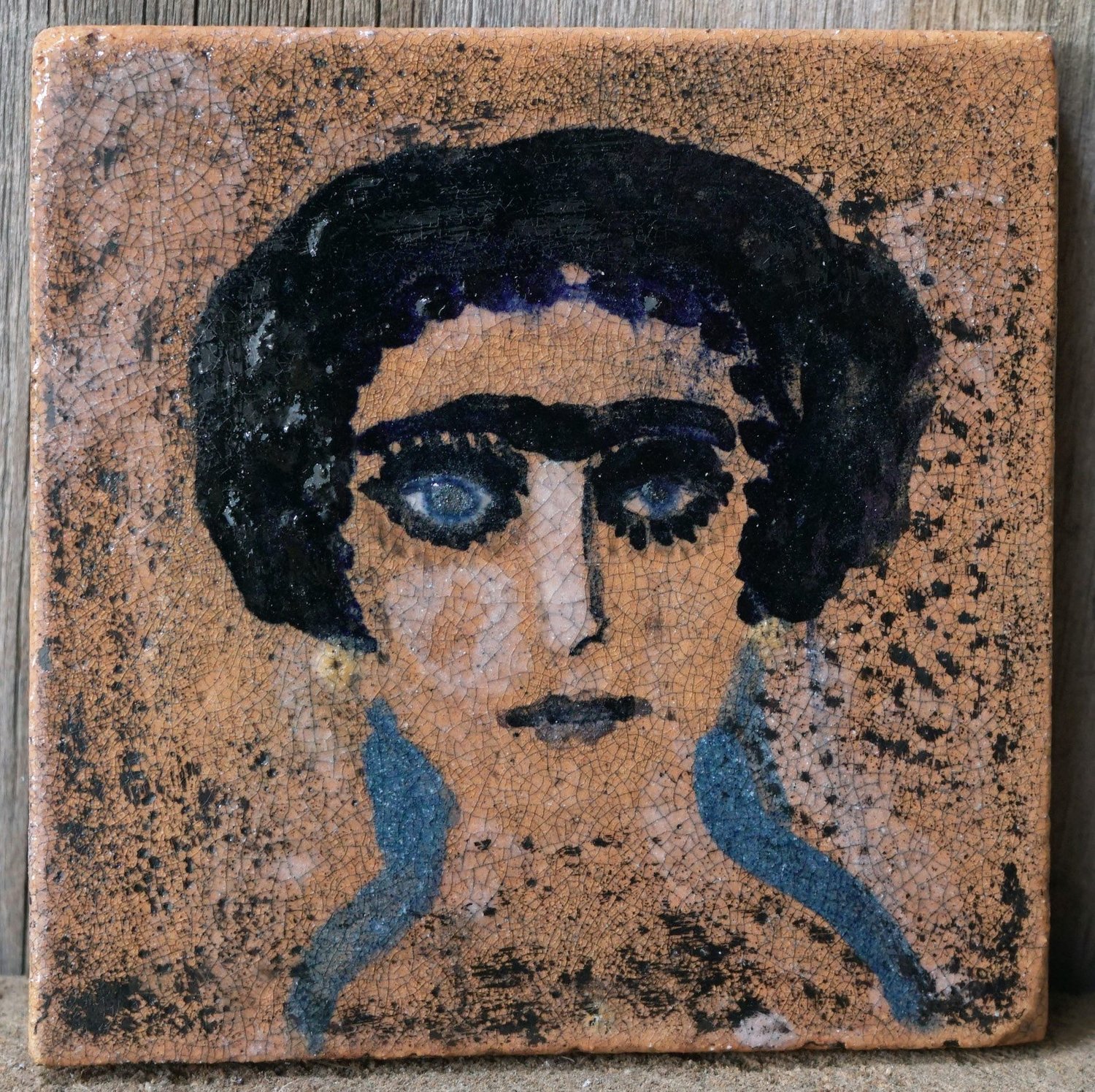 Tutu Kiladze’s “Portrait #3” is a ceramic tile.
