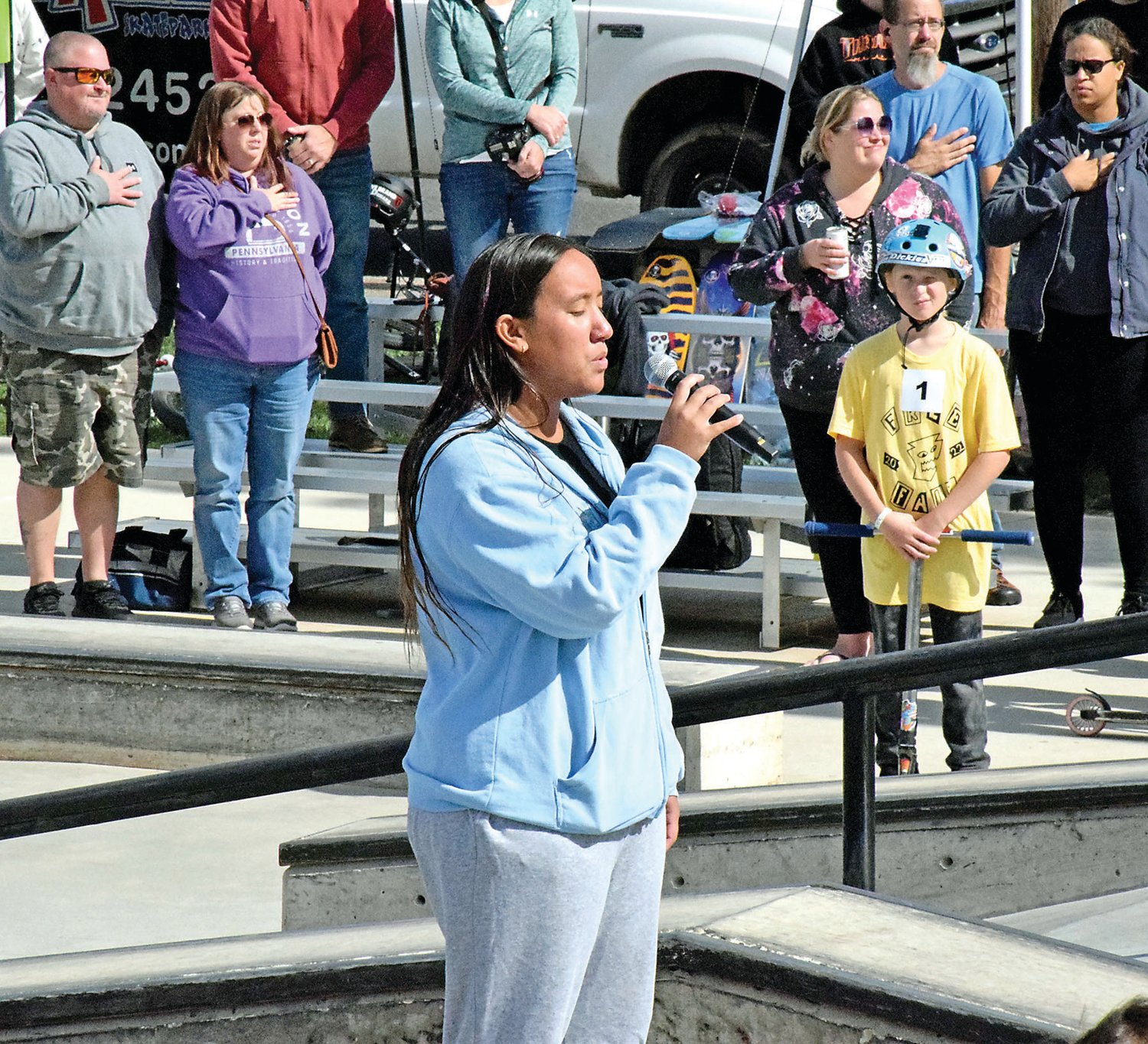Jadyn Fuentes, a Bucks County Community College student, sings the national anthem.