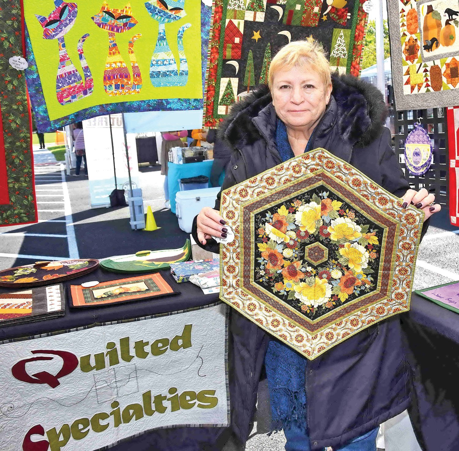 Linda Dunlap with her hand-quilted Specialties.