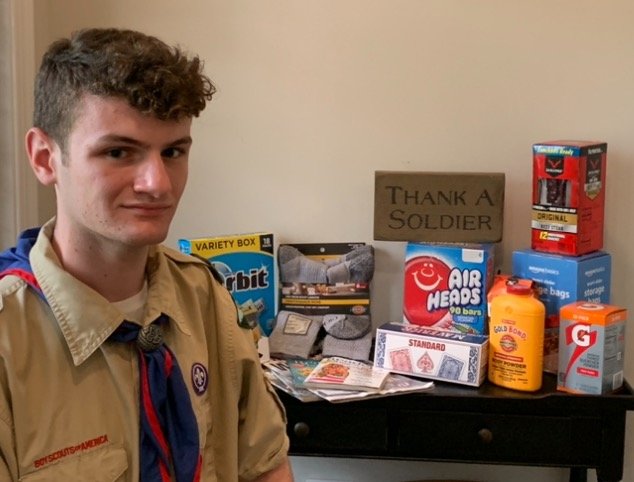 Eagle Scout candidate Andrew Goldberg with some of the goods collected for care packages for troops.