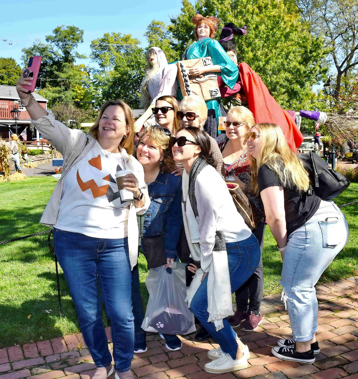 Visitors take a selfie in front of “The Witch Is Back” at the Peddler’s Village annual scarecrow display around the grounds of the shopping mecca. More than a hundred scarecrows created by local residents are on display through Oct. 31.