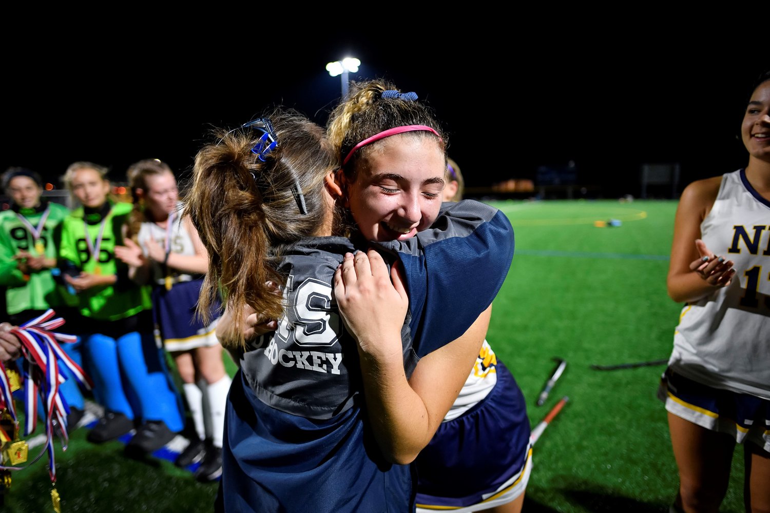 New Hope-Solebury coach Gwen Smith gets a hug from Lauren Trenti as the medals are handed out.