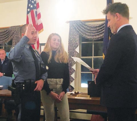 New Yardley Borough full-time police officer Dakota B. Romberger is sworn in by Mayor Chris Harding as Romberger’s girlfriend Haley stands by him.