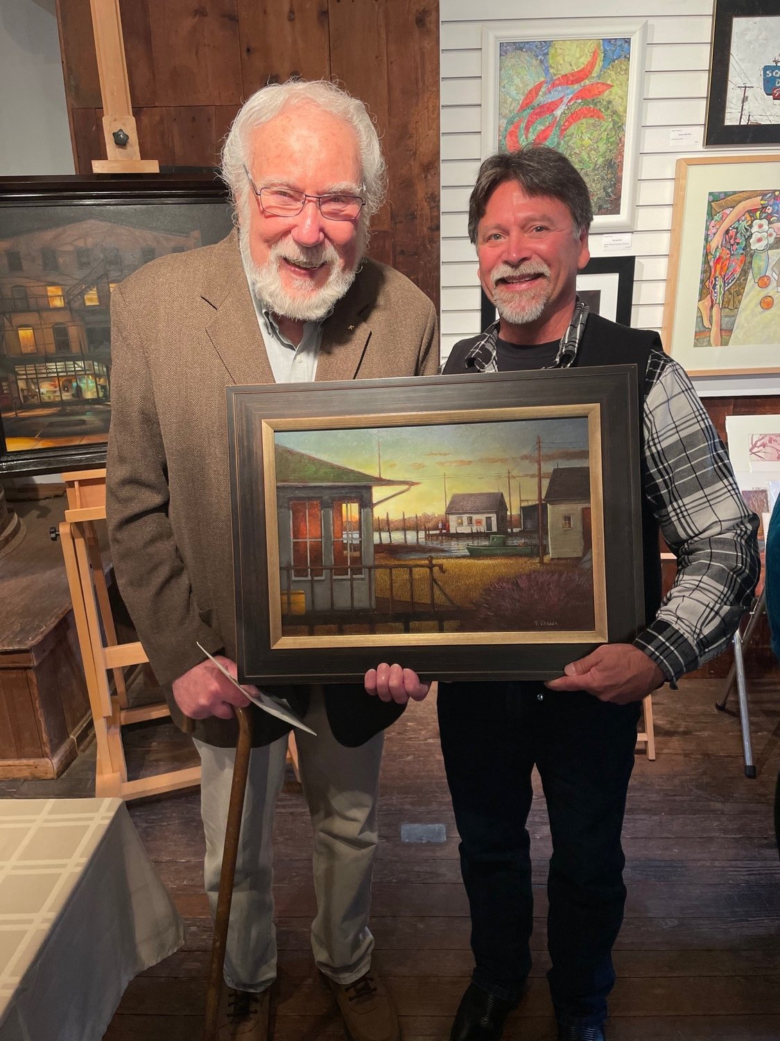Artist Tom Chesar and his painting, “Oyster Creek II,” winner of Most Outstanding Submission, with buyer Michael Leuz.