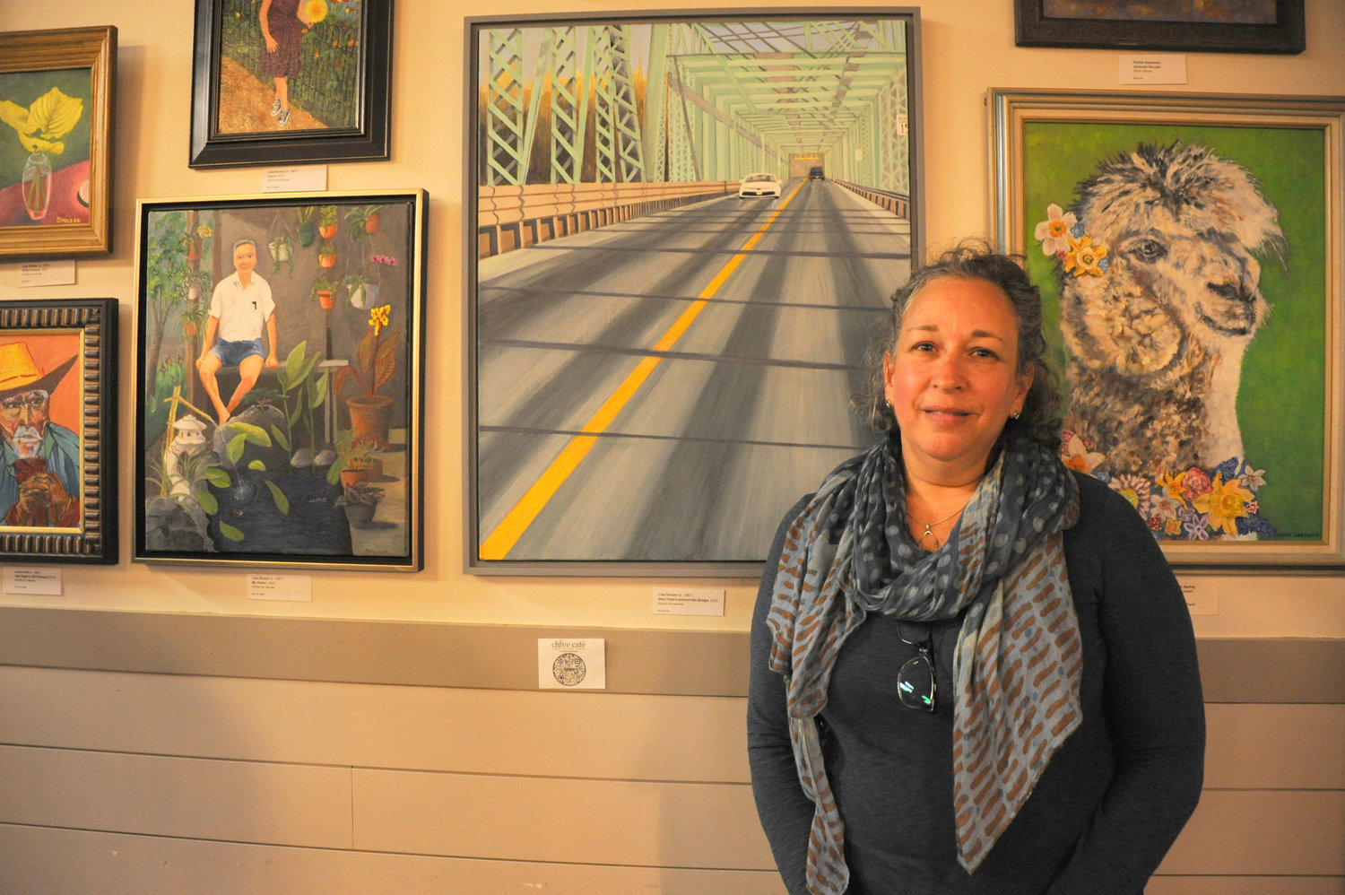 Lisa Stolzer with her painting, “New Hope Bridge.”