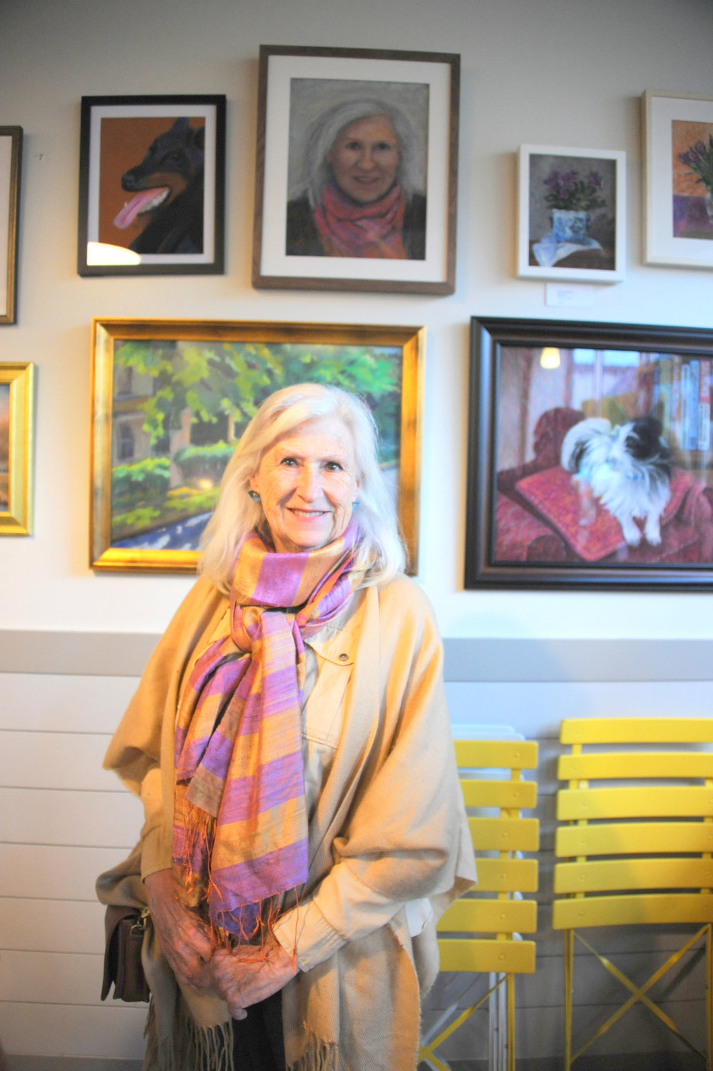 Dee Dee Bowman stands under her portrait painted by
Beverlee Ciccone.