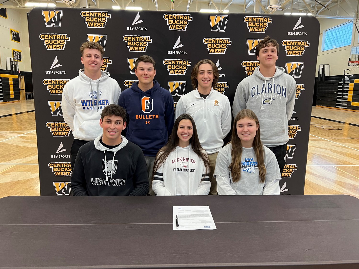 Central Bucks West honored seven seniors at a college commitment ceremony on Nov. 9. From left are: front row, Max McGlone, Kendall Siegle and Margot Haring; back row, Kevin Bukowski, Matt Carr, Julio Ermigiotti and Luke Birkhead.