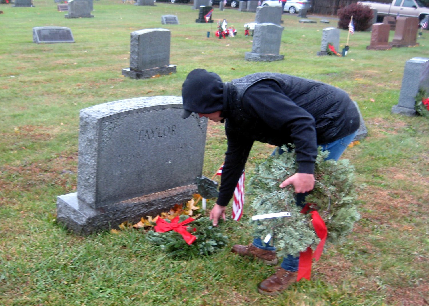 Ron Reilly lays a wreath on a grave during the Northampton Township Veterans Advisory Commission’s 2022 Hometown Heroes Wreath Laying Ceremony.