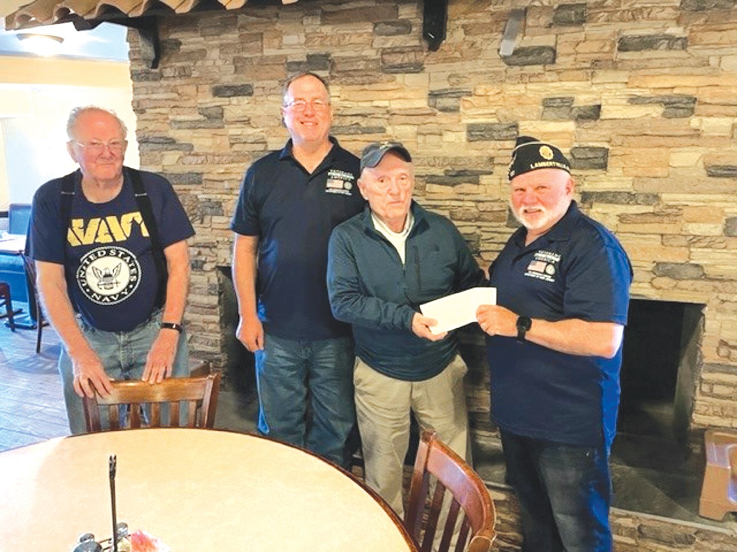 Bill Corboy, president of the Lambertville-New Hope Kiwanis Club, presents the club’s donation to Norb Russo, right, commander, American Legion Post 120.