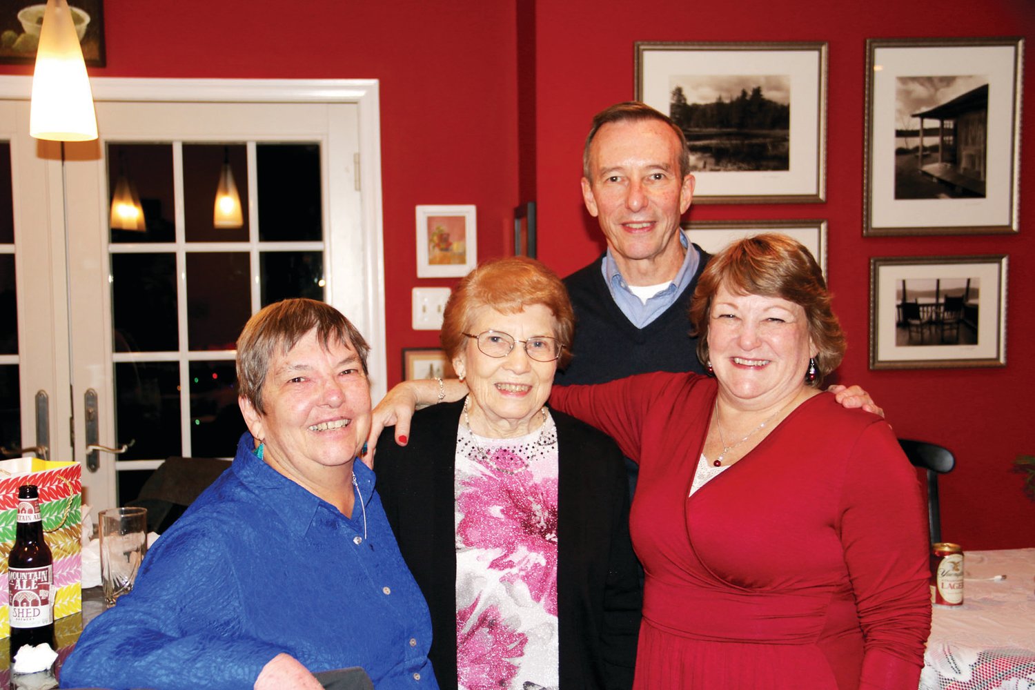 Jean Rutherford, whose family has owned an operated Rutherford's Camera Shop in downtown Doylestown for decades, celebrated her 100th birthday on Dec. 5. From left are her daughter, Susan Rutherford, Jean Rutherford, and daughter, Kristin Daniels. Jean's son, Lee Rutherford is standing with his family.