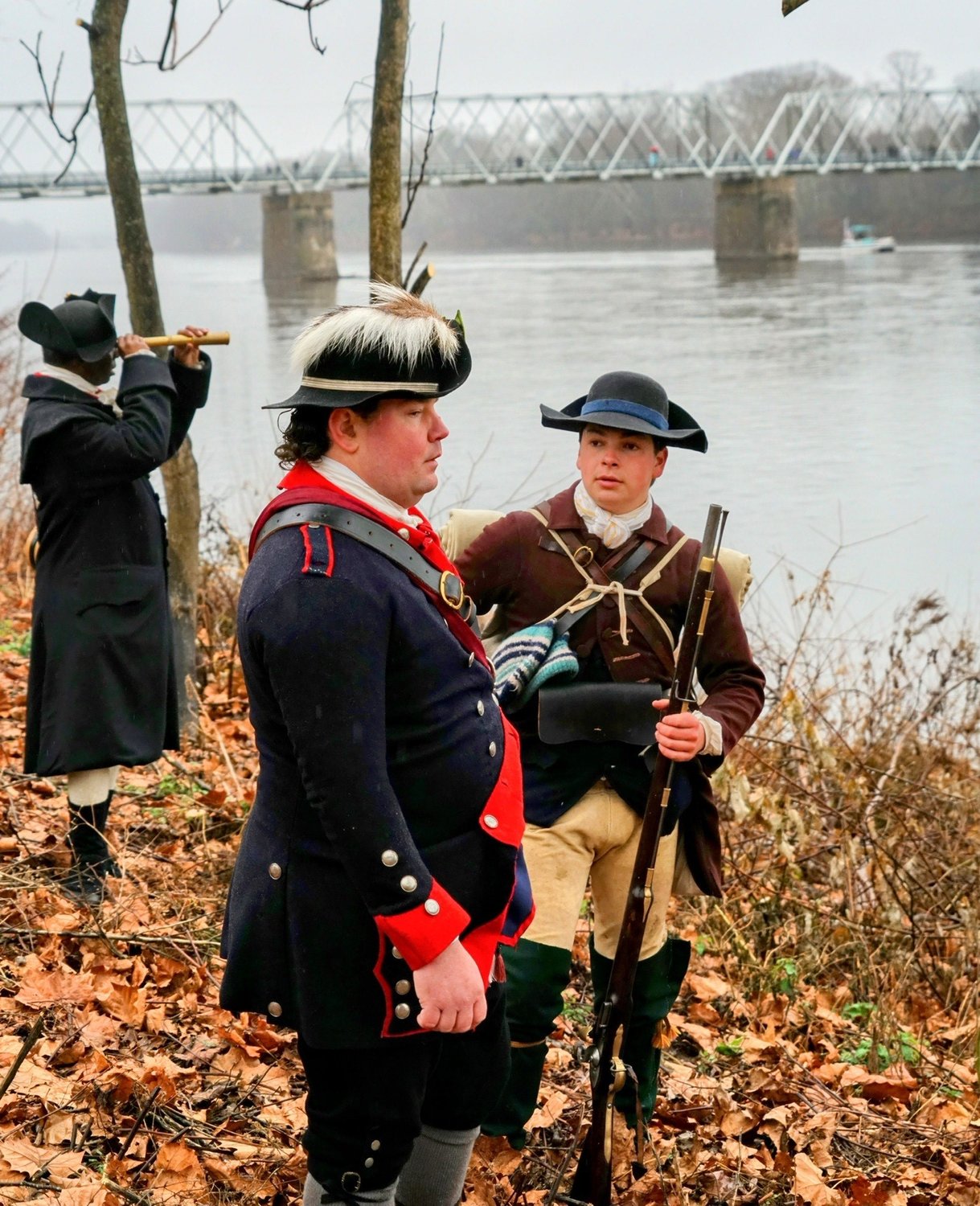 Reenactors gather at the bank of the Delaware River.
