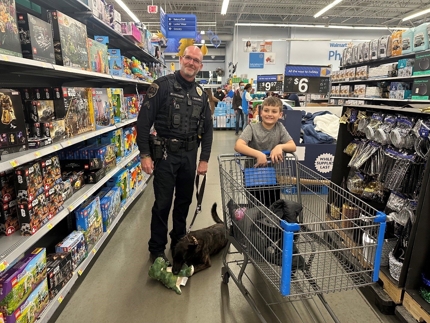 Corporal John Blanchard and Jolie are on hand at the Walmart Supercenter to help students from Barclay, Mill Creek and Titus elementary schools pick out holiday gifts during Warrington Township Police Department’s fifth annual “Shop with a Cop” event.