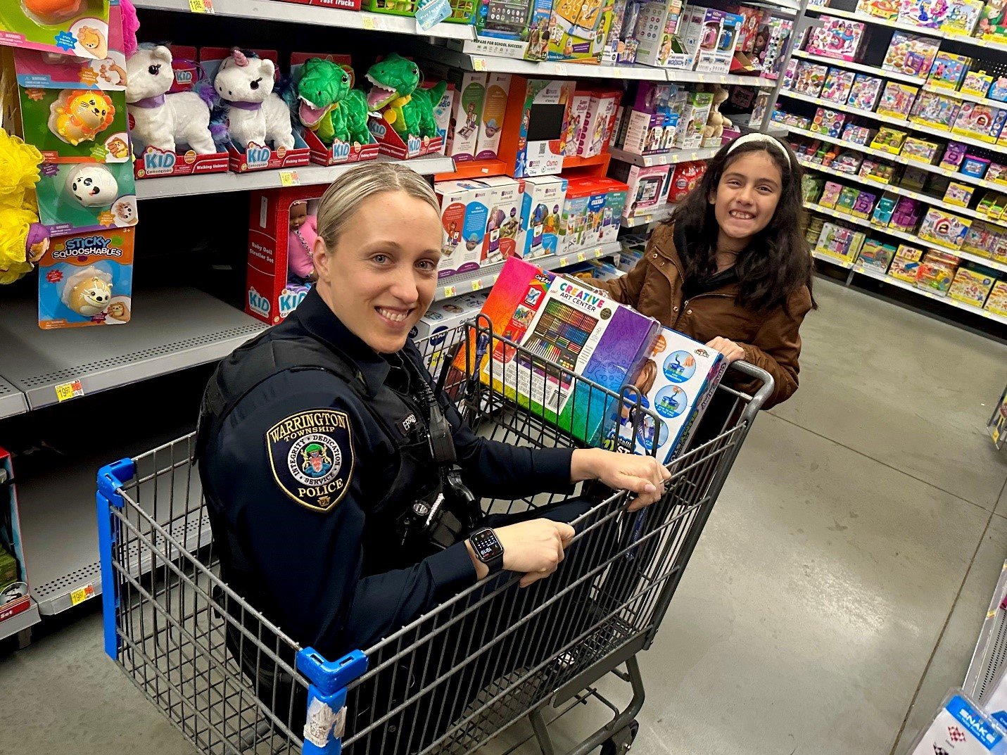Warrington Township Police Officer Kimberly Errigo gets carried away at the “Shop with a Cop” event at the local Walmart Supercenter.