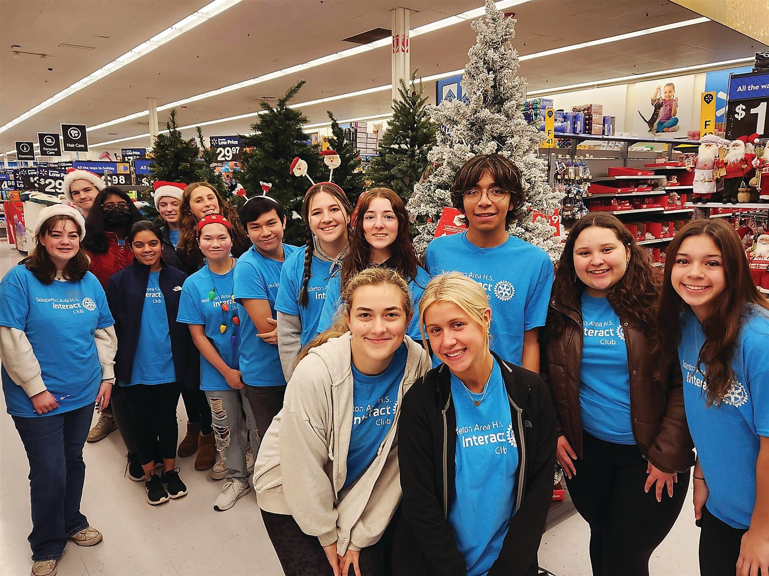 Members of the Souderton-Telford Rotary Interact Club gather to assist officers from Franconia Township, Telford, and Hatfield Police Departments in shopping with local families during the “Shop with a Cop” event.