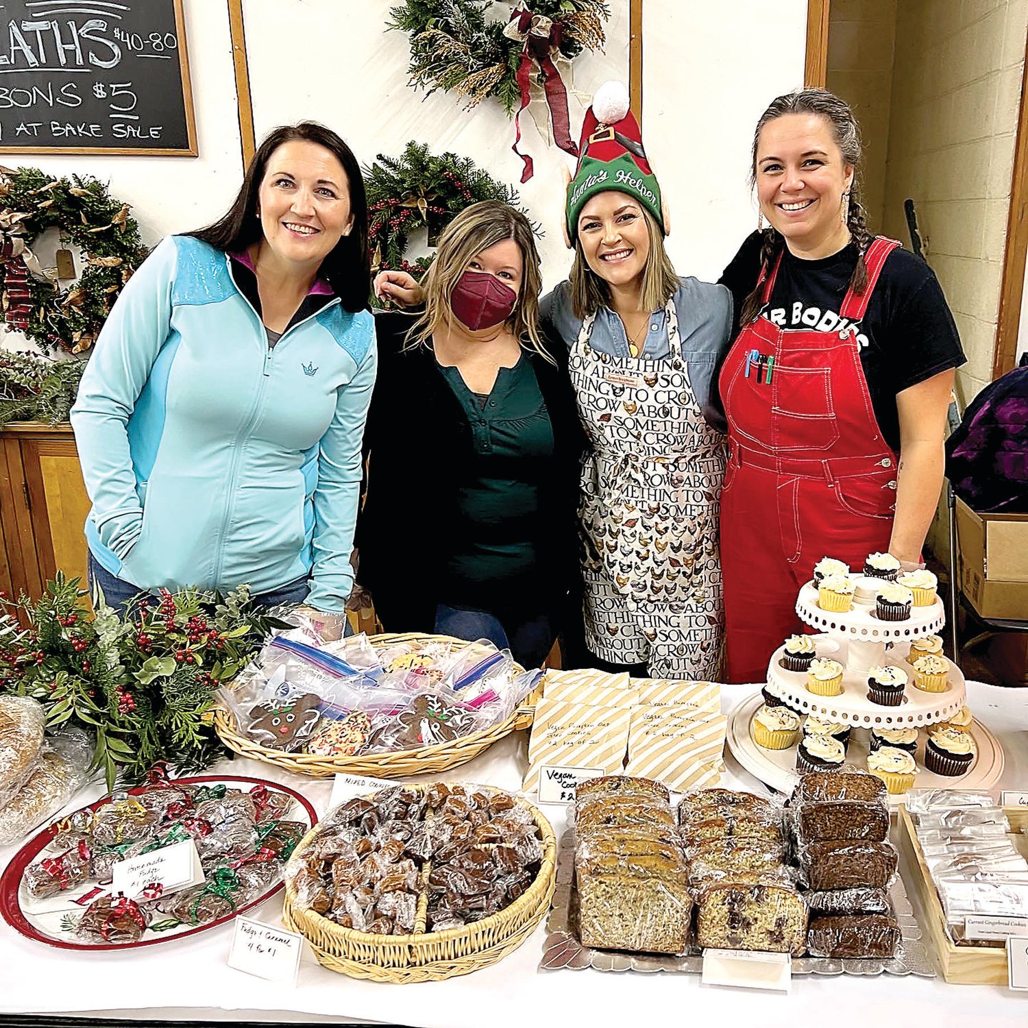 Members of the Buckingham Friends School community gather around the bake sale table.