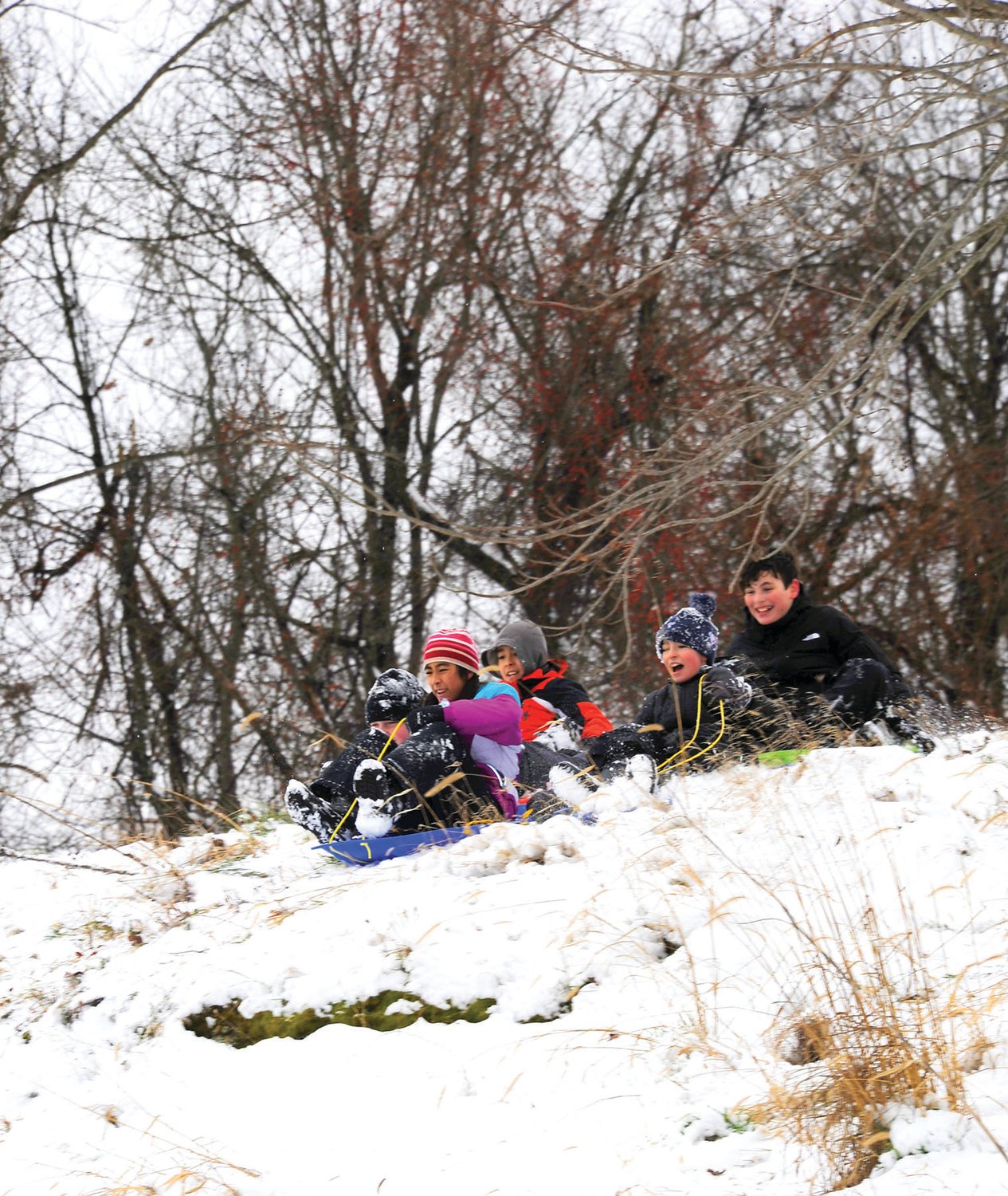 Sledders enjoy the first measurable snow of winter at Magill’s Hill in Solebury Township.