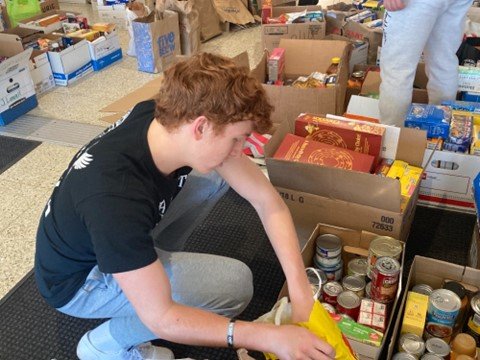 Council Rock High School South senior Owen Ulrick boxes up non-perishable food items during the district’s 18th Annual MLK Day of Service.