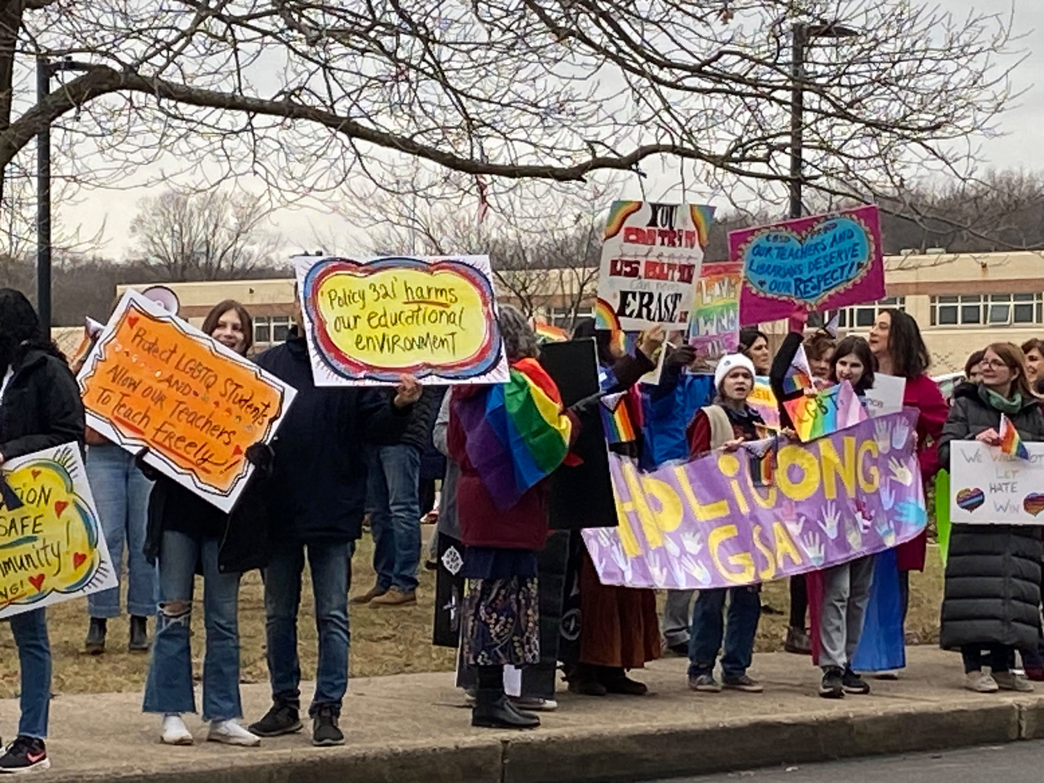 Protesters gathered outside Central Bucks East High School Tuesday to show unity and call for an end to a new district policy that requires Pride flags and other items be removed from classrooms.