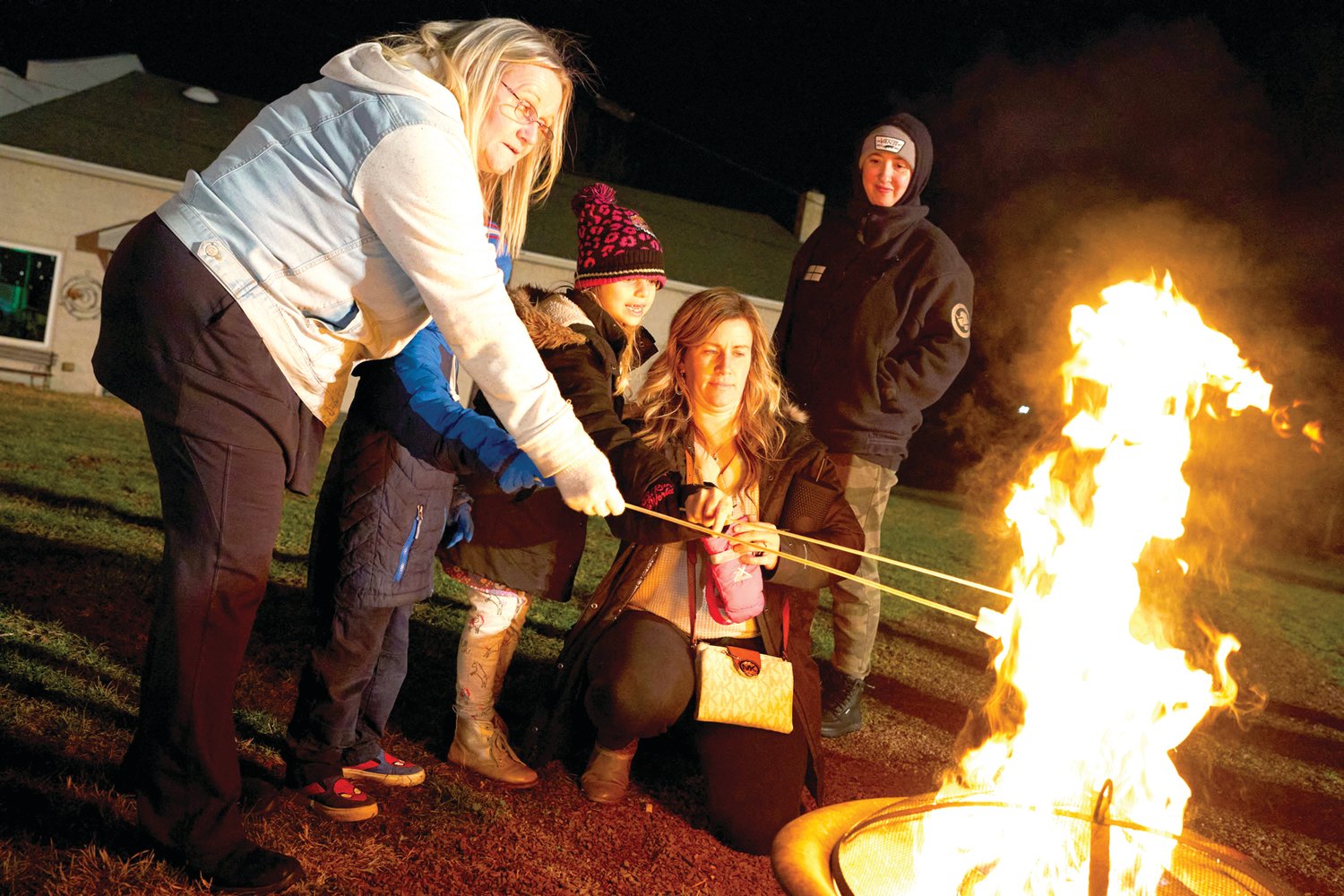 Grandmother Elaine Yetter, Billy, 4, Abby, 7, mom Michelle and Missy Wolfe, all from Bristol, roast marshmallows at Bristol’s Mill Street Fire & Ice Event Friday, Jan. 20, 2023.