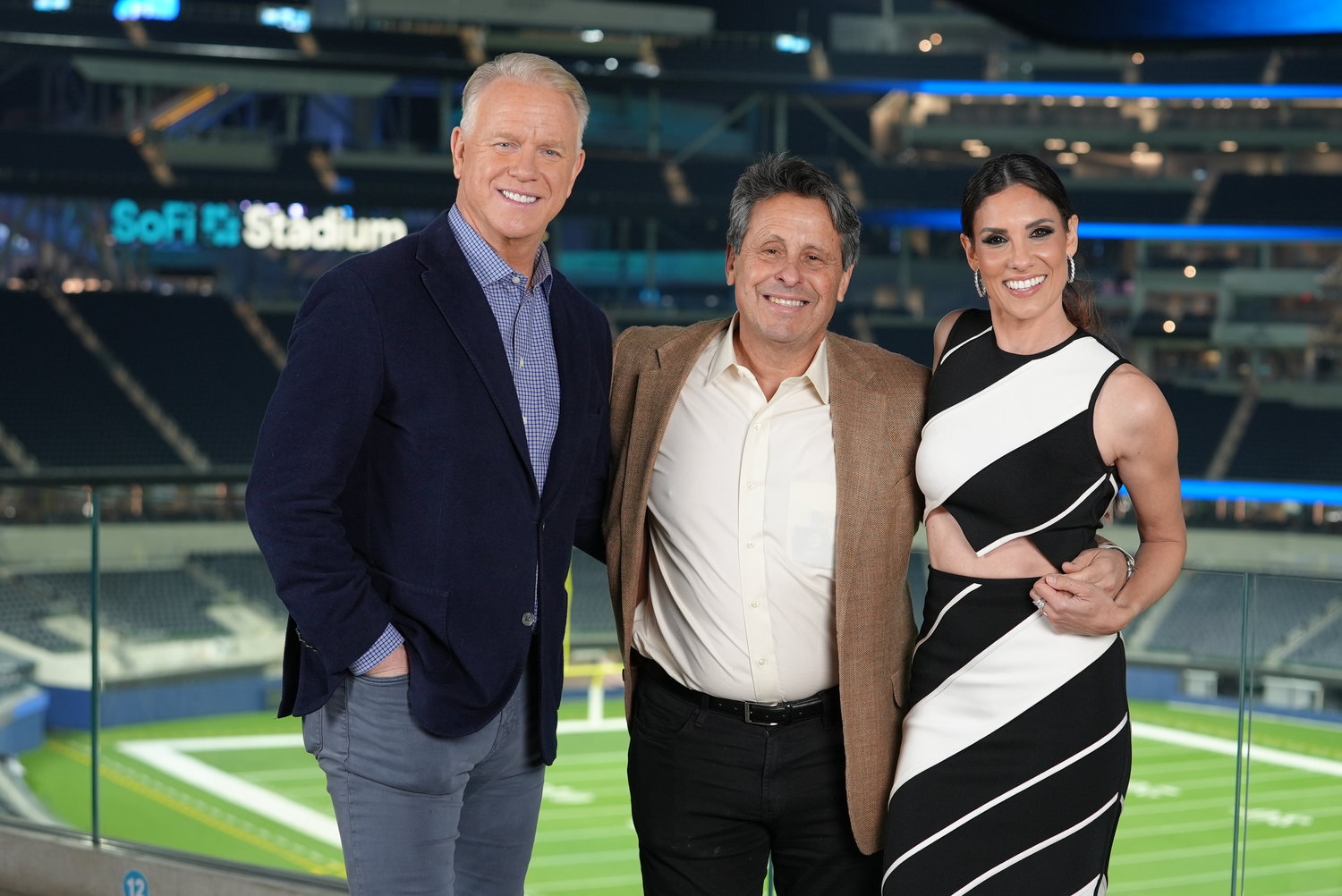 Boomer Esiason, analyst for CBS Sports’ “The NFL Today,” left, with Robert Horowitz, executive producer for Newtown-based Juma Entertainment, and Daniela Ruah, star of CBS’s “NCIS: Los Angeles,” during the filming of “Super Bowl Greatest Commercials: Battle of the Decades” at SoFi Stadium in Los Angeles.